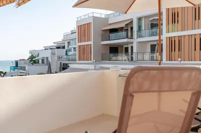 a dining room with a wooden table and chairs at Olhos de Agua Beach Villa by Mycelia in Olhos de Água