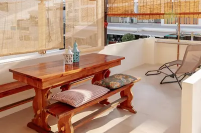 a dining room with a table and a chair at Olhos de Agua Beach Villa by Mycelia in Olhos de Água
