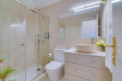 a bathroom with a shower and a toilet and a sink at Carteia Beachfront at Praia da Gaivota in Quarteira