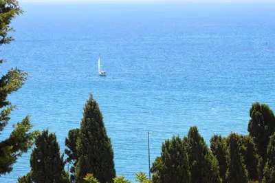 a boat in the water with a sailboat at Boa Vista Apartment with Sea Views and Shared Pool in Albufeira