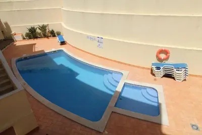 a large swimming pool in a building with a pool at Boa Vista Apartment with Sea Views and Shared Pool in Albufeira