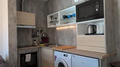 a tea kettle and a toaster in a cabinet at Peaceful Albufeira lodging in Albufeira