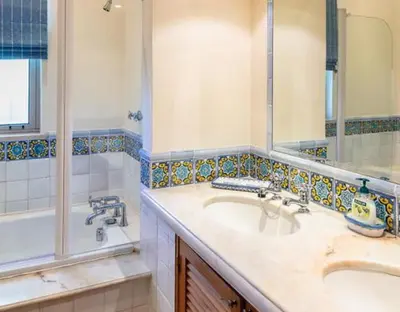 a bathroom with a sink and a tub and a mirror at Traditional property with pool nice large garden in FAO