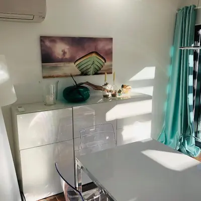 a dining room with a white table and chairs at Algarve Family Escape in Olhos de Água