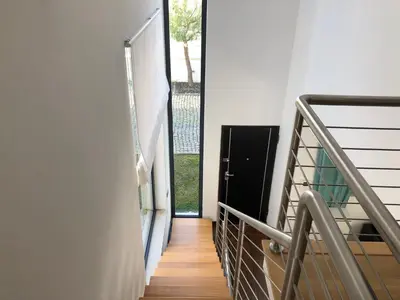 a hallway with a door leading to a balcony at Algarve Family Escape in Olhos de Água