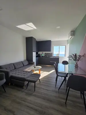 a living room with a couch and a table at O Forte by MTPhomes in Albufeira