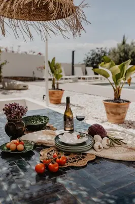 a table with plates of food and a bottle of wine at Luzico ALGARVE in Loulé