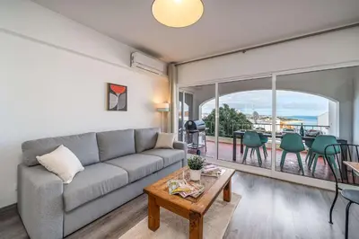 a living room with a couch and a table at Panoramic Sea Views & Balcony BBQ by HostWise in Albufeira