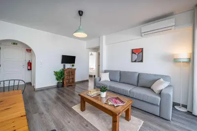 a living room with a couch and a table at Panoramic Sea Views & Balcony BBQ by HostWise in Albufeira