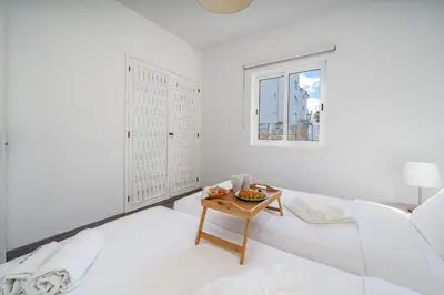 a white room with a white bed and a table at Panoramic Sea Views & Balcony BBQ by HostWise in Albufeira