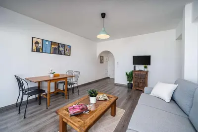 a living room with a couch and a table at Panoramic Sea Views & Balcony BBQ by HostWise in Albufeira