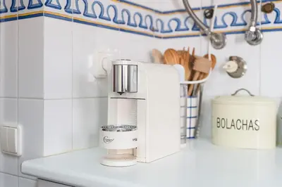 a kitchen counter with a coffee maker on a counter at Villa Ipanema Poolside Living by LovelyStay in Quarteira