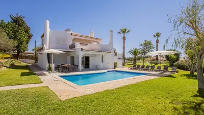 a villa with a swimming pool in a yard at Greice Homes - Villa Carob Tree in Almancil