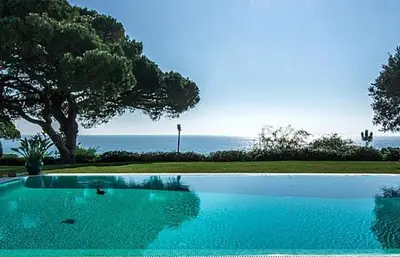a large swimming pool with a view of the ocean at Stunning home with nice pool in Albufeira