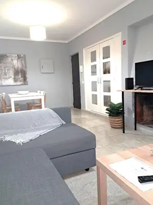 a living room with a bed and a couch and a table at T1 Perto Marina Praia Vilamoura in Vilamoura