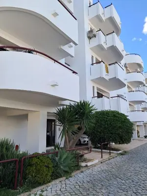 a building with balconies on the side of it at T1 Perto Marina Praia Vilamoura in Vilamoura