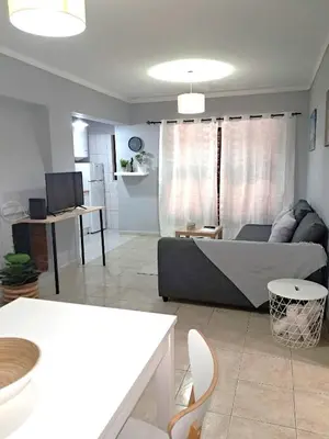 a living room with a couch and a table at T1 Perto Marina Praia Vilamoura in Vilamoura