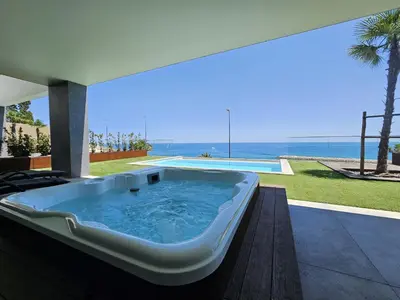 a bath tub on a patio with a view of the ocean at Finisterra Deluxe in Albufeira