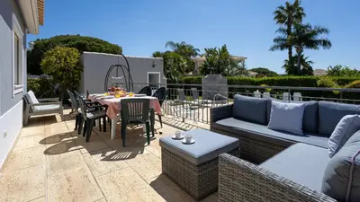 a patio with a couch and a table and chairs at Greice Homes - Villa Vieira in Quarteira