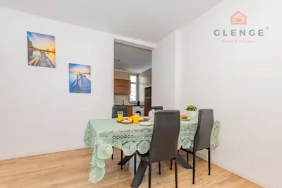 a dining room with a table and chairs at Torre Mira Praia 2 Quartos by Glenge Holiday in Loulé