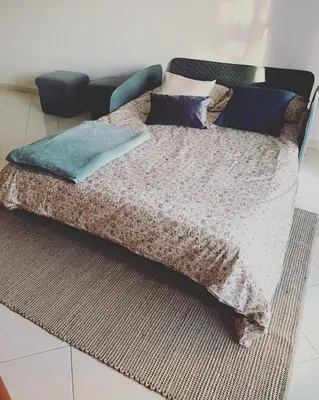 a bed with pillows on it in a room at C Dreams - Comfortable and luminous apartment in Albufeira