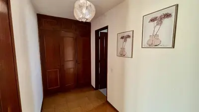 a hallway with two pictures of flowers on the wall at Vilamoura Grand Terrace 2 by Homing in Vilamoura