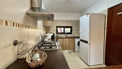 a kitchen with a white refrigerator and a sink at Vilamoura Grand Terrace 2 by Homing in Vilamoura
