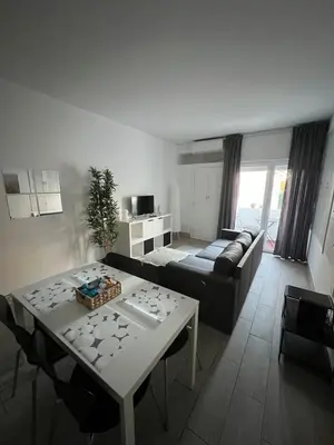 a white table and chairs in a living room at My Cozy Oura Studio in Albufeira