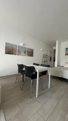 a bedroom with a bed with two pillows and a painting at My Cozy Oura Studio in Albufeira