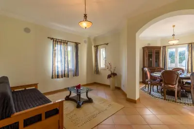 a living room with a couch and a table at Vivenda Alegria in Albufeira