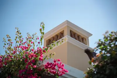 a building with pink flowers in front of it at Villa Serena in Almancil