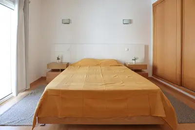 a bedroom with a large bed in a room at Casa Ferreira - Encosta Vista Salgados - BY BEDZY in Guia
