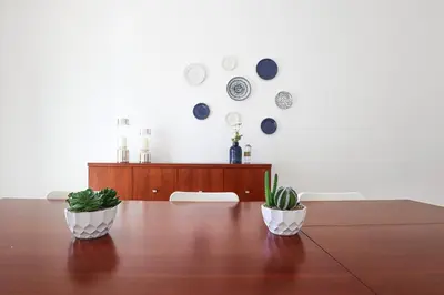 two plants sitting on top of a wooden table at Casa Ferreira - Encosta Vista Salgados - BY BEDZY in Guia
