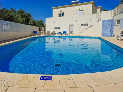 a swimming pool in front of a house at Casa Ferreira - Encosta Vista Salgados - BY BEDZY in Guia