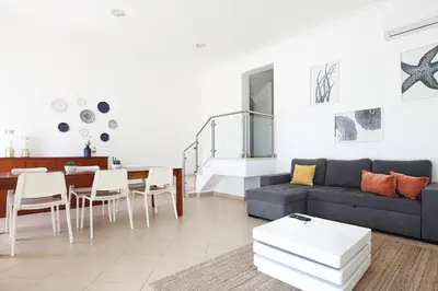 a living room with a couch and a table at Casa Ferreira - Encosta Vista Salgados - BY BEDZY in Guia