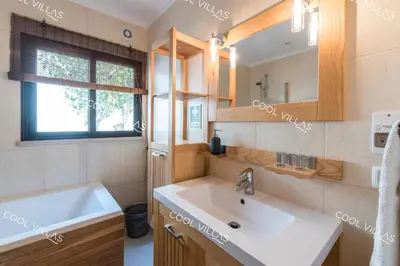 a bathroom with a white sink and a window at Apartamento Laurent - beachfront and city center in Albufeira