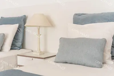 a lamp on a table next to a couch with pillows at Apartamento Laurent - beachfront and city center in Albufeira