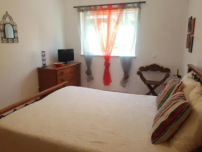 a bedroom with a bed and a television and a window at Albufeira - T2 Old Town Central - 200m Beach in Albufeira