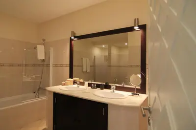 a bathroom with a sink and a large mirror at Apartamentos Valverde - Quinta do Lago in Quinta do Lago