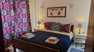 a bedroom with a bed with towels on it at Casa das Flores in Albufeira