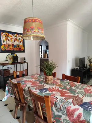 a dining room with a table with a patterned table cloth at Casa das Flores in Albufeira