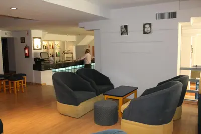 a room with two chairs and a person in a kitchen at Cheerfulway Minichoro Apartamentos in Albufeira