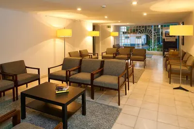 a waiting room with chairs and a table and lamps at Cheerfulway Minichoro Apartamentos in Albufeira