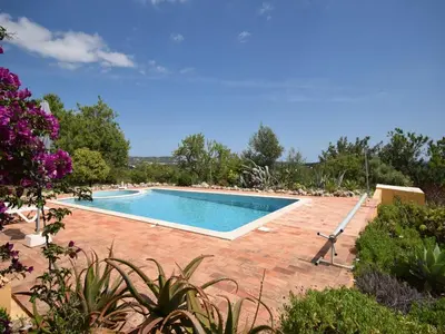 a swimming pool in the middle of a yard at Elegant Loulé Mansion with Pool in Loulé