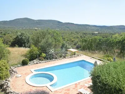 a kitchen with white cabinets and a microwave at Algarve Casa with Pool in Loulé