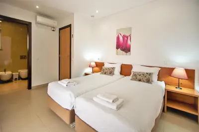 a bedroom with two beds with towels on them at Villa Rafaella II Palace by Atlantic Places in Albufeira