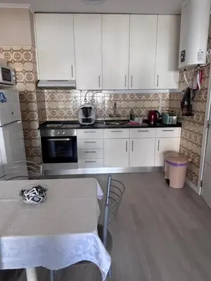 a bedroom with a large bed with two towels on it at TMP Apartamento in Quarteira