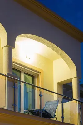 a balcony with a chair on top of a house at D_Loft Sea and Golf in Albufeira