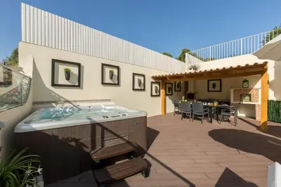 a hot tub on the patio of a house at D_Loft Sea and Golf in Albufeira
