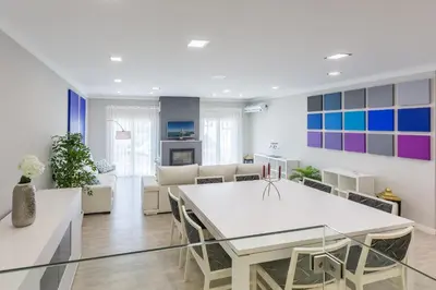a dining room and living room with a white table at D_Loft Sea and Golf in Albufeira